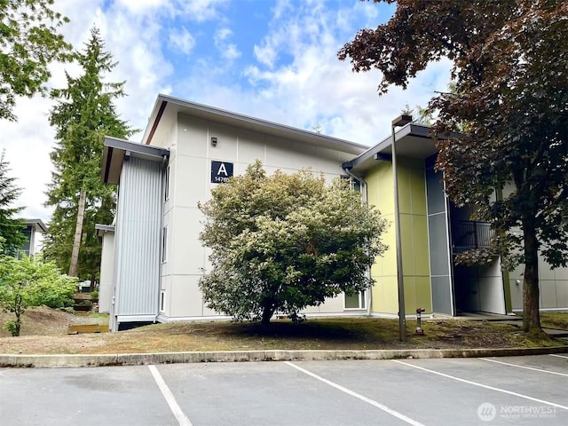 14760 NE 31st St Unit A308, Bellevue, WA 98007 - view of property exterior featuring uncovered parking