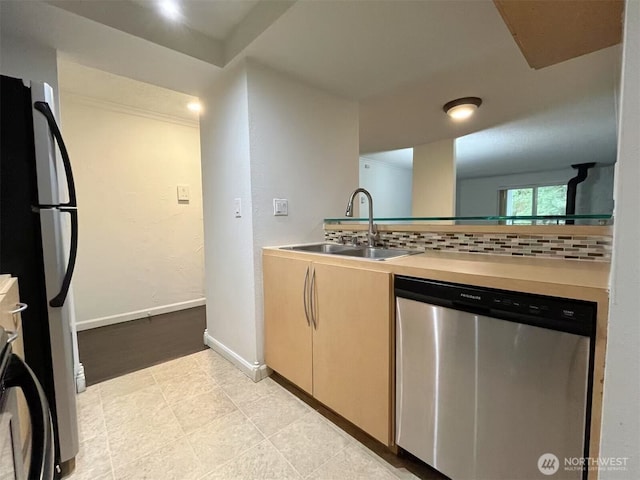 14760 NE 31st St Unit A308, Bellevue, WA 98007 - kitchen featuring dishwasher, a sink, tasteful backsplash, light countertops, and freestanding refrigerator