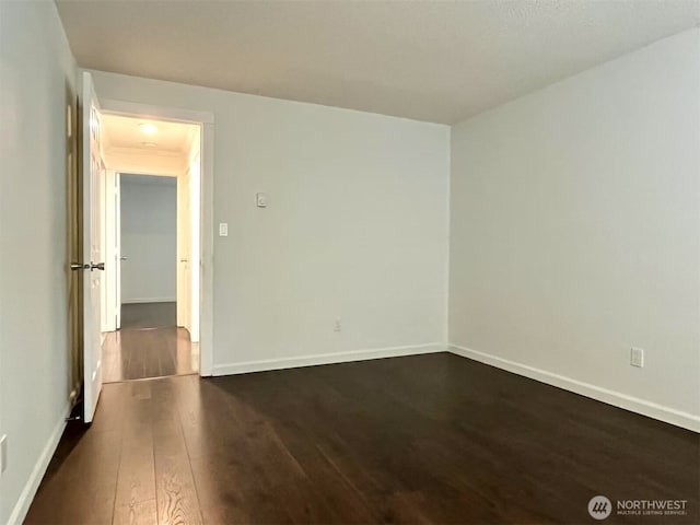 14760 NE 31st St Unit A308, Bellevue, WA 98007 - unfurnished room with dark wood-style floors and baseboards