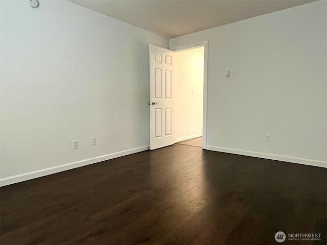 14760 NE 31st St Unit A308, Bellevue, WA 98007 - empty room with dark wood-type flooring and baseboards