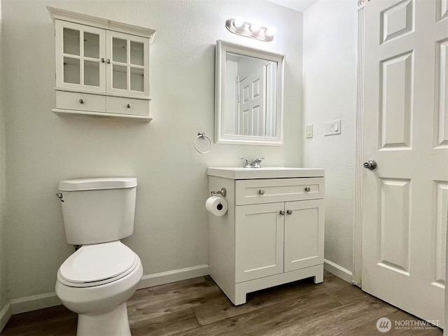 14760 NE 31st St Unit A308, Bellevue, WA 98007 - bathroom with baseboards, wood finished floors, toilet, and vanity