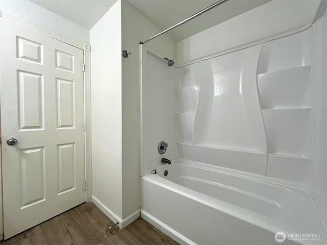 14760 NE 31st St Unit A308, Bellevue, WA 98007 - full bath with baseboards, wood finished floors, and shower / tub combination
