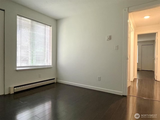 14760 NE 31st St Unit A308, Bellevue, WA 98007 - unfurnished room with baseboard heating, dark wood-type flooring, baseboards, and ornamental molding