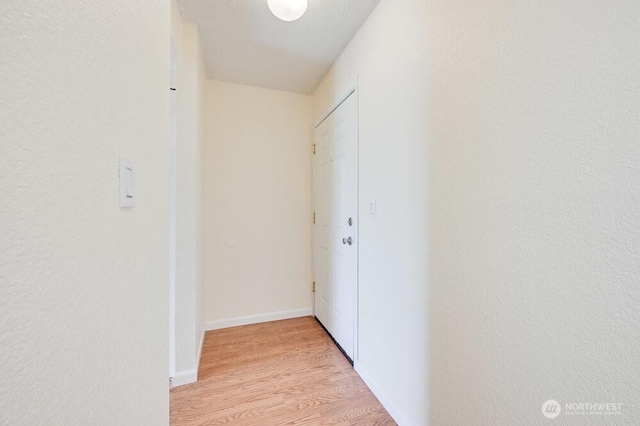 12525 NE 145th Pl Unit F105, Kirkland, WA 98034 - hallway featuring light wood-style floors and baseboards