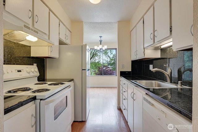 12525 NE 145th Pl Unit F105, Kirkland, WA 98034 - kitchen featuring white appliances, a sink, a textured ceiling, under cabinet range hood, and a chandelier