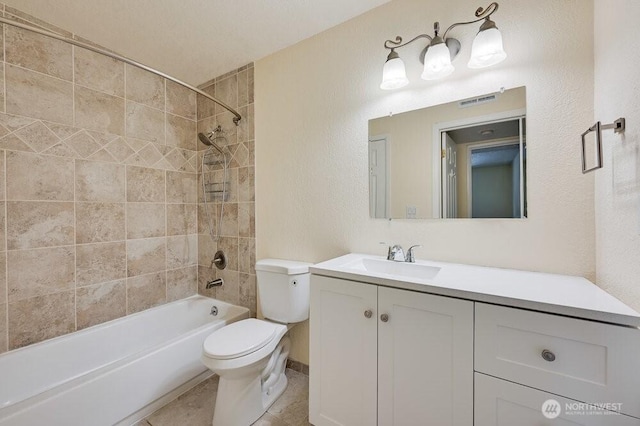 12525 NE 145th Pl Unit F105, Kirkland, WA 98034 - full bathroom featuring toilet, vanity, washtub / shower combination, a textured wall, and tile patterned floors