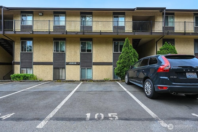 12525 NE 145th Pl Unit F105, Kirkland, WA 98034 - view of apartment building / complex with uncovered parking