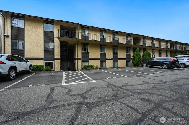 12525 NE 145th Pl Unit F105, Kirkland, WA 98034 - view of apartment building / complex with uncovered parking