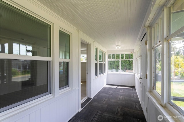 6835 S I St, Tacoma, WA 98408 - unfurnished sunroom featuring carpet floors and a decorative wall