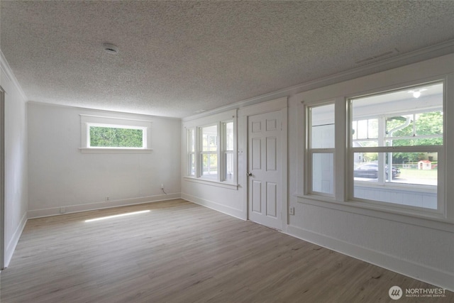 6835 S I St, Tacoma, WA 98408 - unfurnished room with a textured ceiling, wood finished floors, baseboards, and crown molding