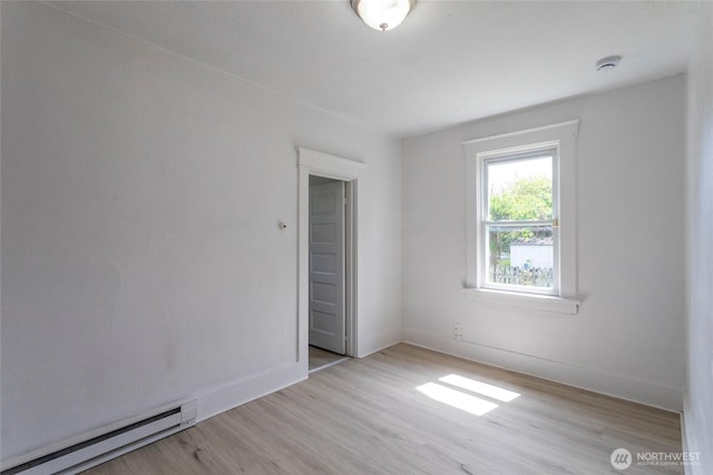 6835 S I St, Tacoma, WA 98408 - empty room featuring a baseboard heating unit, light wood-style flooring, baseboards, and a smoke detector