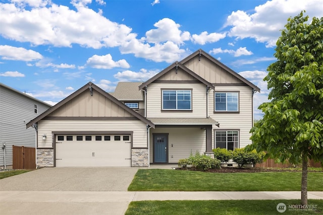 craftsman-style home featuring board and batten siding, driveway, an attached garage, and stone siding