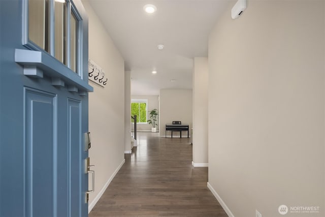 corridor featuring baseboards, dark wood-style floors, and recessed lighting