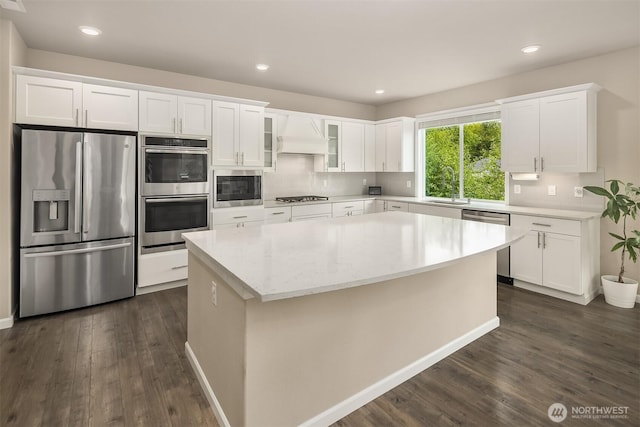 kitchen with appliances with stainless steel finishes, dark wood-style floors, white cabinets, and recessed lighting