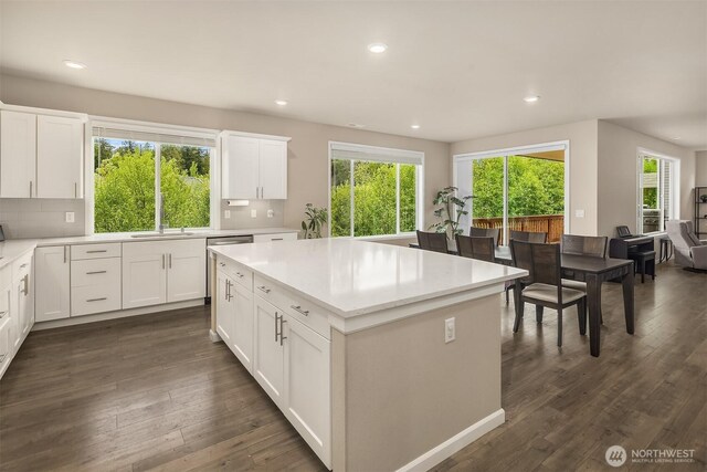 kitchen with recessed lighting, a sink, light countertops, and dark wood-style flooring