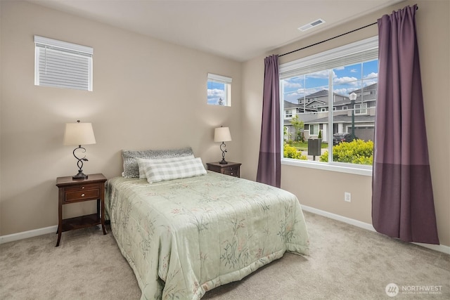 bedroom featuring baseboards and light carpet