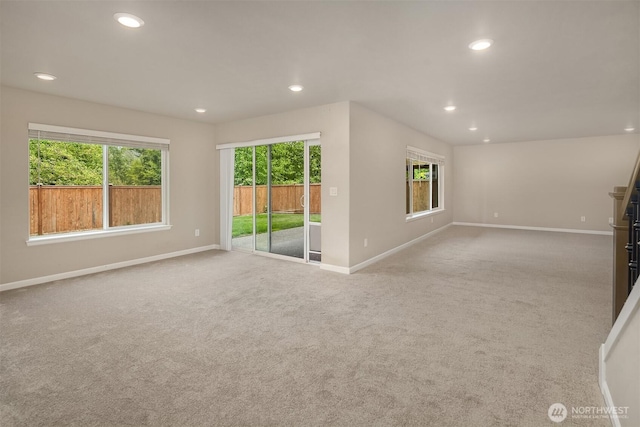 unfurnished living room featuring baseboards, carpet, and recessed lighting