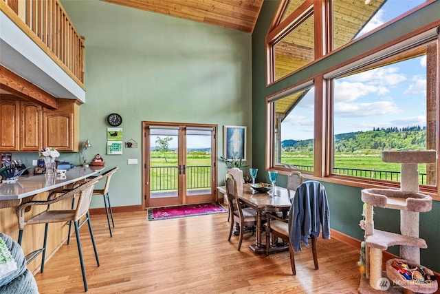 6238 Willow Grove Rd, Longview, WA 98632 - dining area featuring high vaulted ceiling, french doors, healthy amount of natural light, light wood-style flooring, and baseboards