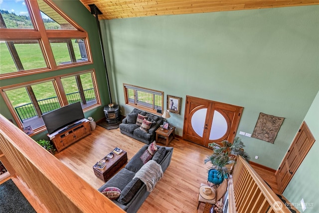 6238 Willow Grove Rd, Longview, WA 98632 - living room with high vaulted ceiling, wood finished floors, wooden ceiling, and a wood stove