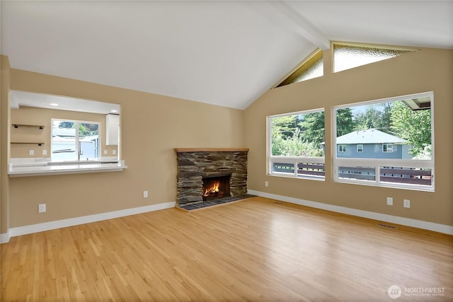 unfurnished living room with wood finished floors, a fireplace, and baseboards