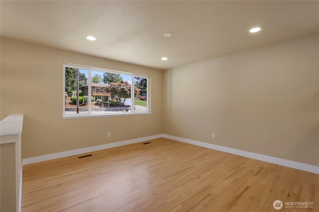 unfurnished room featuring light wood finished floors, recessed lighting, and baseboards