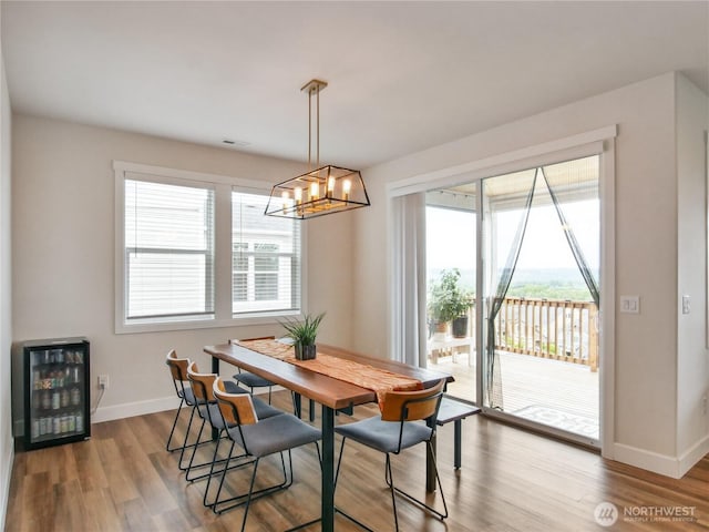 2668 83rd Avenue Ct E, Edgewood, WA 98371 - dining room featuring beverage cooler, healthy amount of natural light, baseboards, and wood finished floors