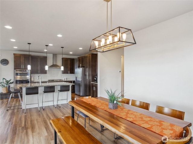 2668 83rd Avenue Ct E, Edgewood, WA 98371 - dining space with light wood finished floors, recessed lighting, and a chandelier