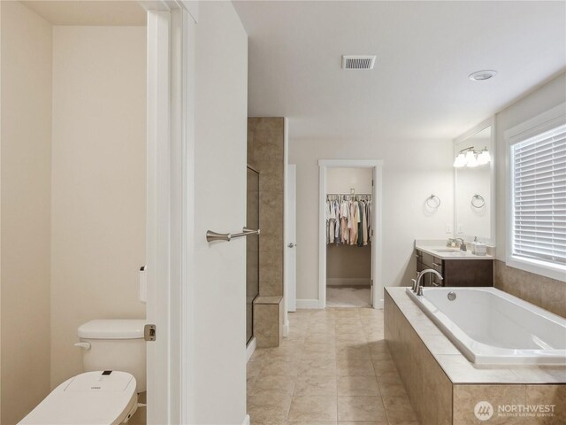 2668 83rd Avenue Ct E, Edgewood, WA 98371 - full bath featuring toilet, a garden tub, a tile shower, a walk in closet, and vanity