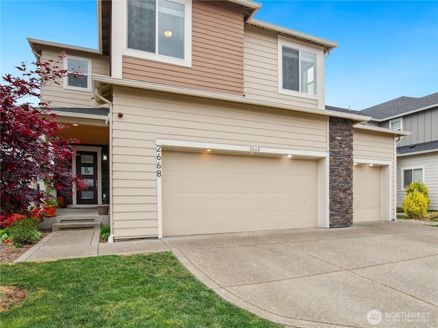 2668 83rd Avenue Ct E, Edgewood, WA 98371 - view of front facade with an attached garage, stone siding, and driveway