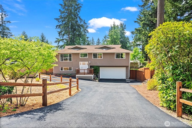 104 Point Fosdick Cir NW, Gig Harbor, WA 98335 - raised ranch featuring asphalt driveway, a garage, and fence