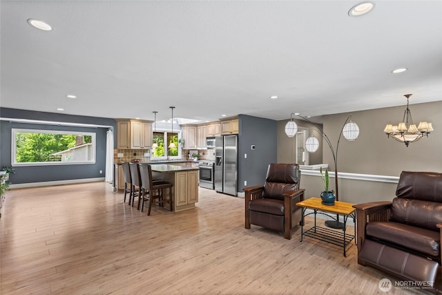 104 Point Fosdick Cir NW, Gig Harbor, WA 98335 - living room featuring a chandelier, recessed lighting, light wood-style flooring, and baseboards