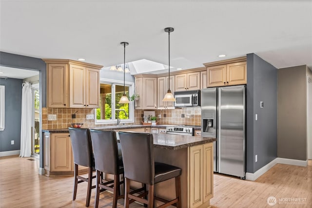 104 Point Fosdick Cir NW, Gig Harbor, WA 98335 - kitchen featuring appliances with stainless steel finishes, baseboards, tasteful backsplash, dark countertops, and recessed lighting