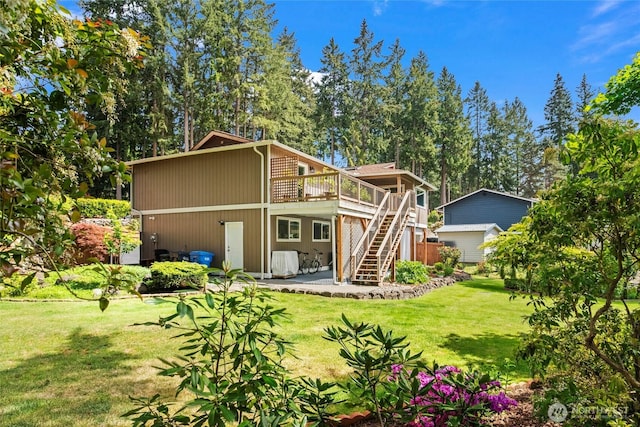 104 Point Fosdick Cir NW, Gig Harbor, WA 98335 - rear view of house featuring stairs, a deck, a yard, and a patio