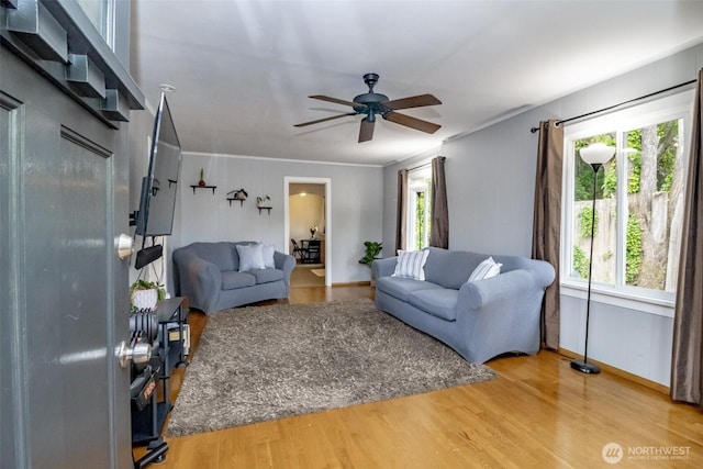 213 S 70th St, Tacoma, WA 98408 - living room featuring a ceiling fan, wood finished floors, crown molding, and baseboards