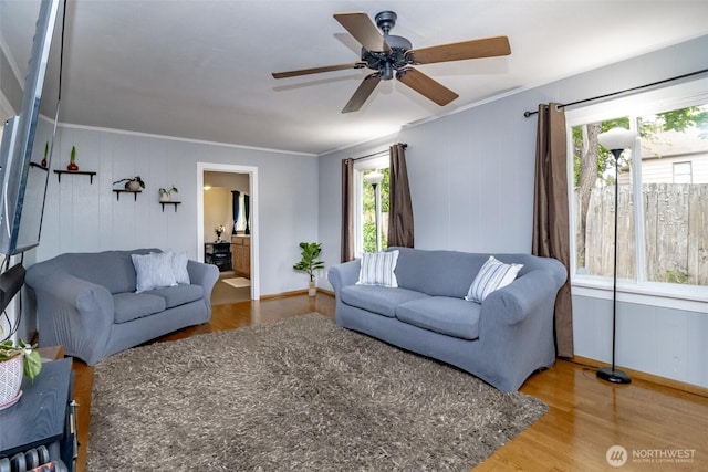 213 S 70th St, Tacoma, WA 98408 - living room featuring wood finished floors, crown molding, ceiling fan, and baseboards