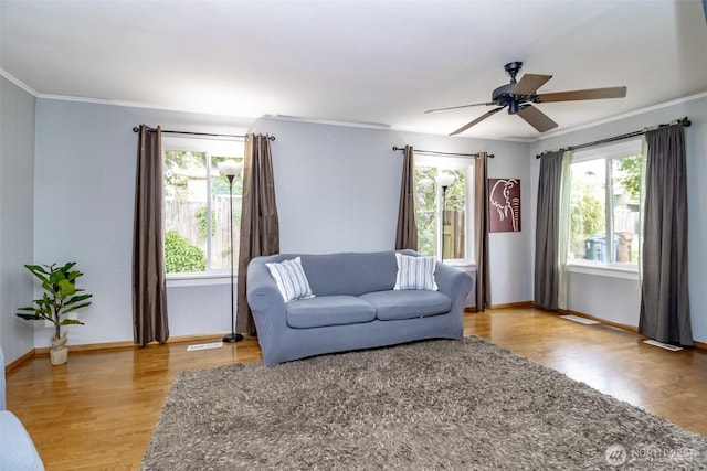 213 S 70th St, Tacoma, WA 98408 - living area featuring light wood-style flooring, ceiling fan, ornamental molding, and baseboards