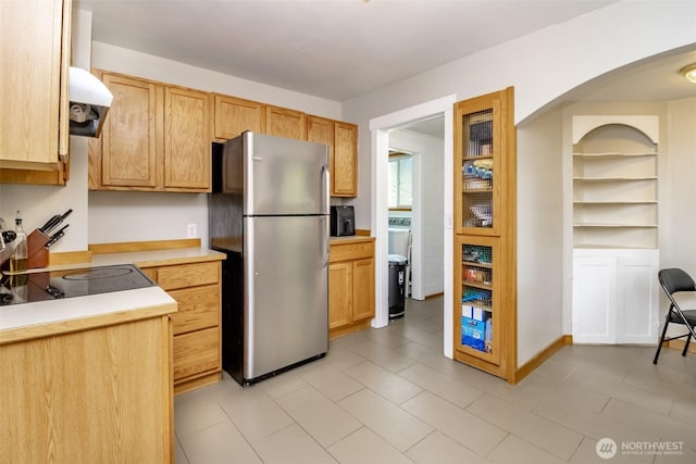 213 S 70th St, Tacoma, WA 98408 - kitchen with freestanding refrigerator, light countertops, extractor fan, washer / clothes dryer, and black electric cooktop