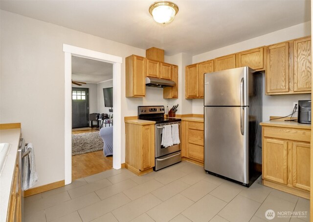 213 S 70th St, Tacoma, WA 98408 - kitchen with stainless steel appliances, under cabinet range hood, light countertops, baseboards, and light brown cabinetry