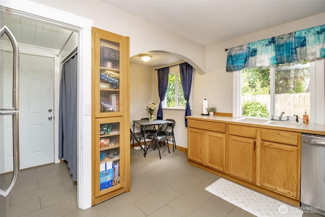 213 S 70th St, Tacoma, WA 98408 - kitchen with stainless steel dishwasher, arched walkways, a sink, and light countertops