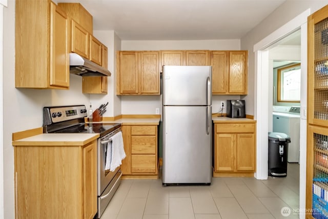 213 S 70th St, Tacoma, WA 98408 - kitchen featuring appliances with stainless steel finishes, under cabinet range hood, separate washer and dryer, and light countertops