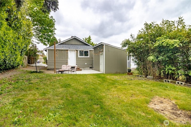213 S 70th St, Tacoma, WA 98408 - rear view of property with a yard, an outbuilding, and a patio