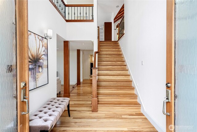 16915 SE 39th St, Bellevue, WA 98008 - foyer entrance with wood finished floors, stairs, a high ceiling, and baseboards