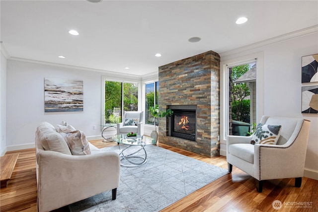 16915 SE 39th St, Bellevue, WA 98008 - living area featuring crown molding, baseboards, a stone fireplace, wood finished floors, and recessed lighting