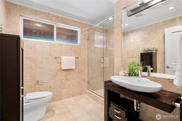16915 SE 39th St, Bellevue, WA 98008 - bathroom featuring tile walls, ornamental molding, a sink, a stall shower, and tile patterned flooring