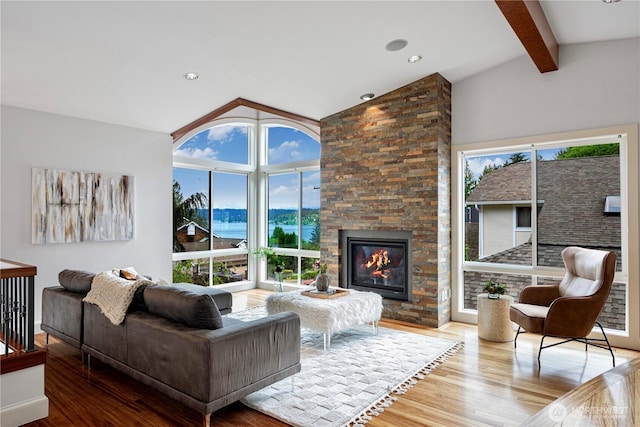 16915 SE 39th St, Bellevue, WA 98008 - living room featuring wood finished floors, a fireplace, and a water view