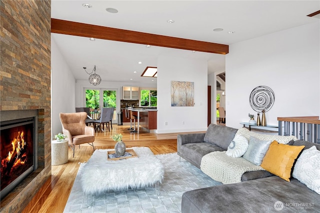 16915 SE 39th St, Bellevue, WA 98008 - living area with light wood-style floors, beamed ceiling, a fireplace, and recessed lighting