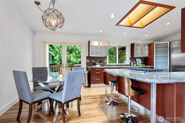16915 SE 39th St, Bellevue, WA 98008 - dining area with light wood-style floors, recessed lighting, vaulted ceiling, and baseboards