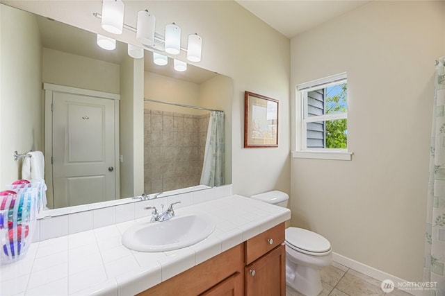 bathroom with toilet, tile patterned flooring, curtained shower, vanity, and baseboards