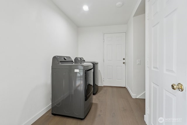 1115 207th Pl NE, Sammamish, WA 98074 - laundry area with washer and clothes dryer, wood finished floors, and baseboards