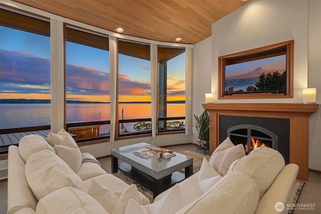 3316 SW 172nd St, Burien, WA 98166 - living area featuring a water view, wood ceiling, recessed lighting, a warm lit fireplace, and baseboards